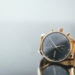 Black dial watch with gold case and link bracelet